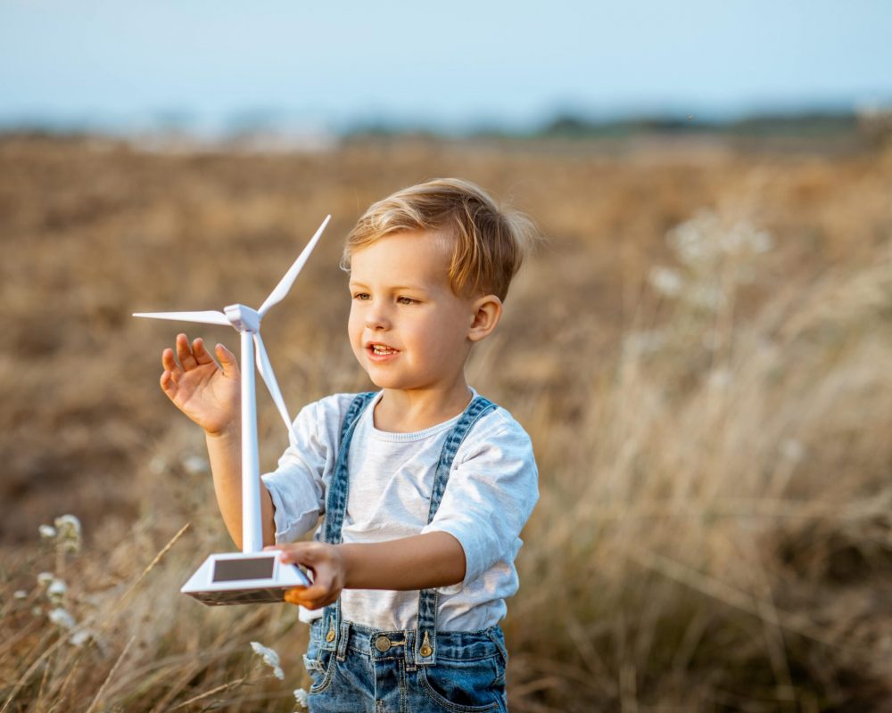 boy-playing-with-toy-wind-turbine-outdoors-2022-01-18-23-53-41-utc-min boy-playing-with-toy-wind-turbine-outdoors-2022-01-18-23-53-41-utc-min